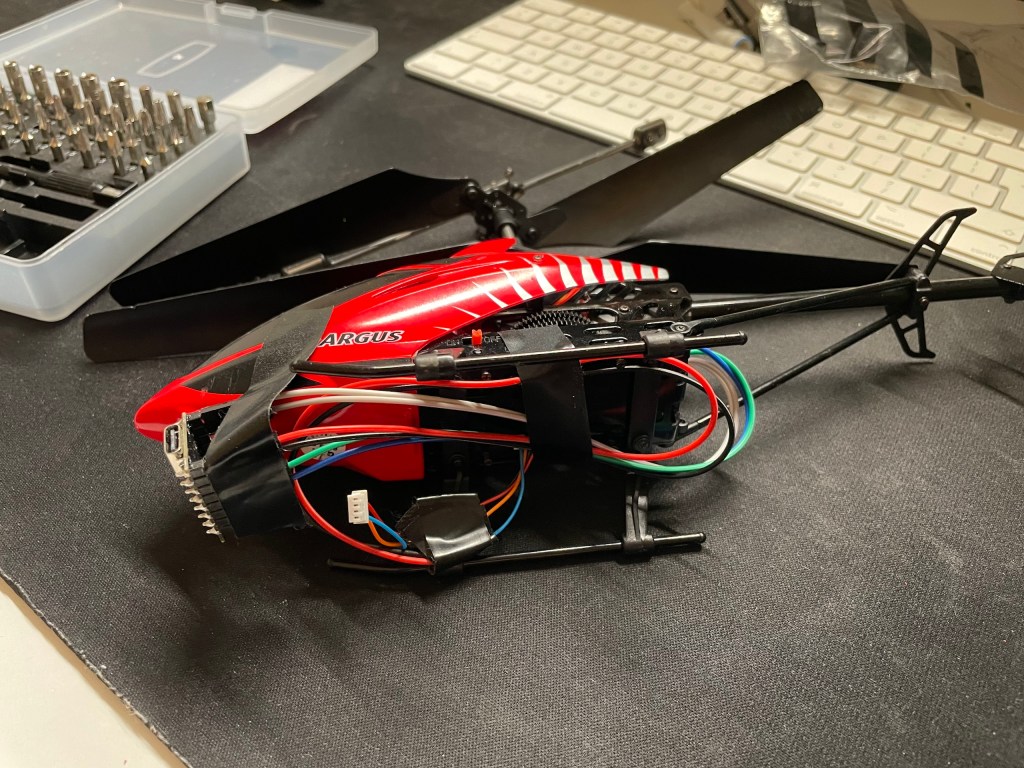 Photo of RC Helicopter showing the underside with wires taped to the body for test flights.